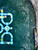 Aerial view of water park with algae accumulation around clear water, Pula, Croatia.