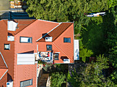 Aerial view of couple having breakfast on roof terrace. Fun concept for people living in the city.