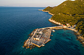 Aerial view of a small pier for ferry along the coast facing the Adriatic Sea near Lastovo, Croatia.