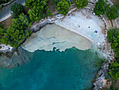 Aerial view of serene beach with turquoise water and algae accumulation, Pula, Croatia.