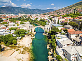 Aerial view of people crossing Old Bridge over Neretva river in Mostar, Bosnia and Herzegovina.