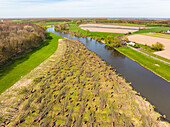 Aerial view of river Linge with road and pollarded willow forest, Marienwaerdt, Betuwe, Gelderland, Netherlands.