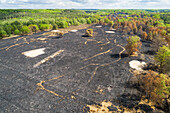 Aerial view of burned forest and heath area after the immense wildfire of April 2020, Meinweg national park, Herkenbosch, Limburg, Netherlands