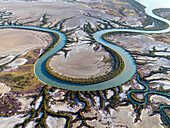 Aerial view of serpentine river winding through coastal wetlands and marshes, Accident Inlet, Gulf of Carpentaria, Karumba, Australia.