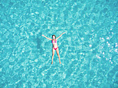 Beautiful woman swimming in transparent sea