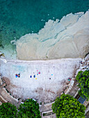 Aerial view of beautiful beach with algae accumulation and turquoise water, Pula, Croatia.