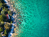 Aerial view of crystal clear water along the coastline with rocky seabed on Veliki Brijun Island, Brijuni National Park, Istria, Croatia.