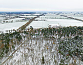 Aerial view of mixed forest and countryside in autumn with snow, De Witte Bergen, Asten, De Peel, Noord-Brabant, Netherlands.