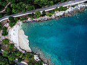 Aerial view of a beautiful beach with algae accumulation and turquoise waters, Pula, Croatia.