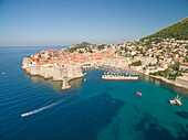 Aerial view of old city of Dubrovnik (Croatia) with old port in front. Dubrovnik is popular tourist attraction on Adriatic.