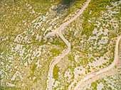 Aerial view of curved roads in mountains.