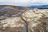 Aerial view of the 4WD road F208 from Landmannalaugar to Sprengisandur with power line in desolate landscape, highlands of Iceland