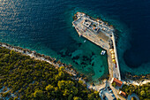 Aerial view of a small pier for ferry along the coast facing the Adriatic Sea near Lastovo, Croatia.
