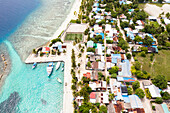 Aerial view of the local island Omadhoo, harbour area with soccer Alif Dhaal Atoll, Maldives.
