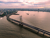 Aerial view of the beautiful Sealink bridge and vibrant skyline over the Arabian Sea at sunset, Worli, Mumbai, India.