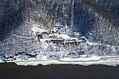 Aerial view of the serene and picturesque Makaryevsky Monastery surrounded by a snowy forest and river, Kazan, Tatarstan, Russia.