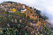 Panoramic aerial sunset view of the castle Yburg with floating fog in autumn, Varnhalt, Black Forest, Baden Baden, Baden Wine Route, Germany.