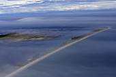 Aerial view of serene and tranquil coastline with fog and mist over water, Irkutsk Oblast, Russia.