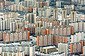 Aerial view of a bustling urban landscape with high-rise buildings and residential apartments in winter, Moscow, Russia.