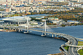 Aerial view of the cable stayed bridge over the mouth of the Little Neva with a scenic cityscape and modern stadium, Saint Petersburg, Russia.