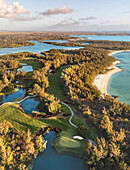 Panoramic aerial view of the island Ile aux Cerfs with golf course at sunrise, Flacq, Mauritius.