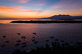 Aerial view at group of boats anchored next Gili Trawangan island during sunset.