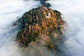 Panoramic aerial sunset view of the castle Yburg with floating fog in autumn, Varnhalt, Black Forest, Baden Baden, Baden Wine Route, Germany.