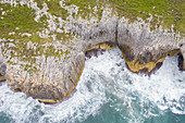 Aerial view of waves crashing against the shore near Puertas de Vidiago, Asturias, Costa Verde, Spain