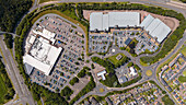 Aerial view of a retail park with stores and parking lot, Exeter, United Kingdom.