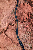 Aerial View of the abstract rock formation around the winding road at Goblin Valley State Park in Utah, USA