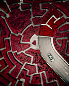 Aerial view of a car exiting a garage with a maze garden on top, Shanghai, China.