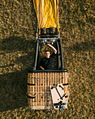 Aerial view of a person standing in hot air balloon basket gondola, Vilnius, Lithuania.
