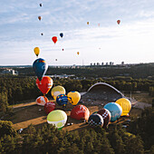 Vilnius, Lithuania - 3 July 2021: Aerial view of hot air balloons taking off from Vingis park and flying over Vilnius in summer time, Lithuania.