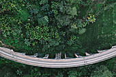 Aerial top down view of famous Nine arch railway bridge going through green jungle landscape in Demodara, Ella, Sri Lanka.