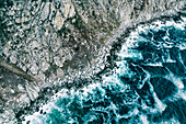 Aerial view of ocean breaking on rocks at Chapmans Peak Drive, Cape Town, South Africa.