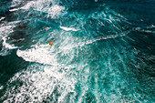 Aerial view of kitesurfer crossing the ocean at Kite Beach in Santa Maria, Sal, Cape Verde.