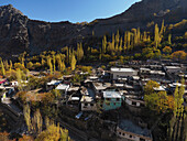Aerial view of remote village nestled in mountainous region with traditional architecture, Skardu, Pakistan.