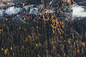 Aerial view of clouds and forest on the hills of Kaprun, Austria.