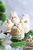 Meringue Easter nests with cream, eggnog and chocolate eggs