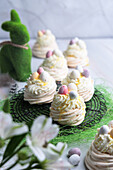 Meringue Easter nests with cream, eggnog and chocolate eggs