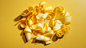 Yellow courgette strips on a yellow background