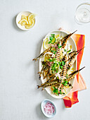Grilled garfish with lemon, oregano and pickled onions