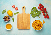 Ingredients for Italian pasta dishes - tomatoes, olives, basil, oil