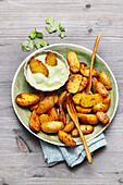 Curried potato wedges with coriander dip from the air fryer