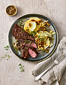 Venison steaks with vegetable and nut gratin