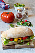 Baguette sandwich with lettuce, tomatoes and mozzarella