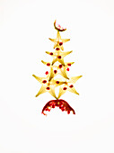 Pomegranate and star fruit slices arranged in the shape of a Christmas tree