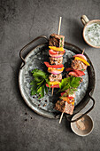Grilled kebab skewers with yoghurt sauce and herbs