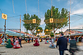 Seville, Spain, Apr 19 2018, Feria de Abril in Seville dazzles with vibrant colors and lively festivities under stunning twilight lights.