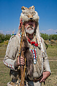 A mountain man in period dress with a coyote-skin hat at the Fort Bridger Mountain Man Rendezvous in Wyoming.